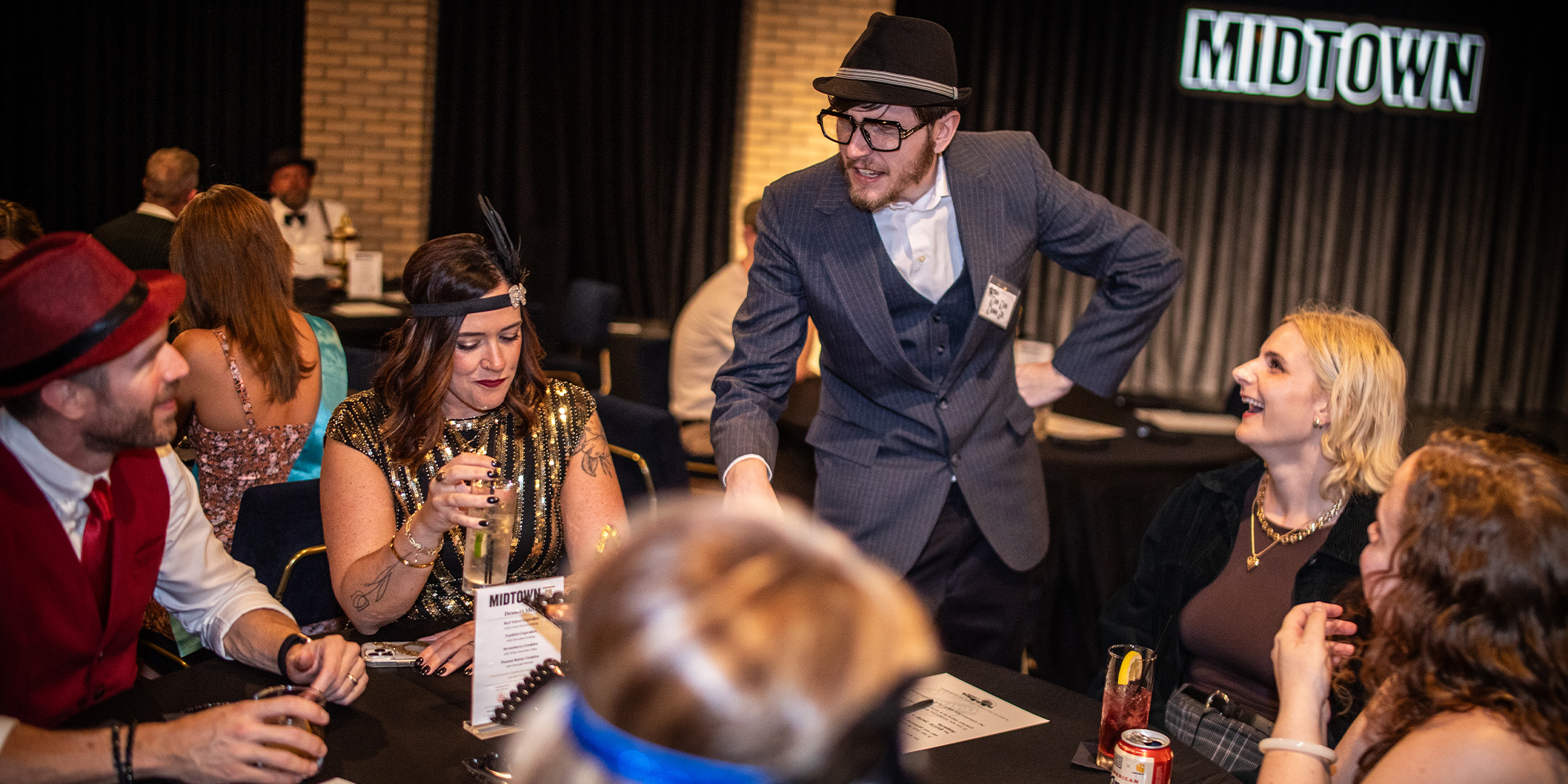 Guests at a Murder Mystery Company public dinner show in Atlanta